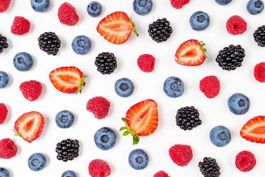 Pattern of strawberries, blueberries, raspberries, and blackberries on a white background