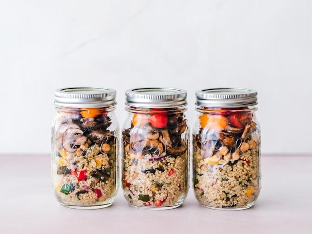 jars of Quinoa Sweet Potato salad with a delightful maple vinaigrette, a healthy fall salad.