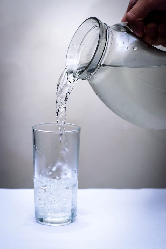 Pouring drinking water in a glass.