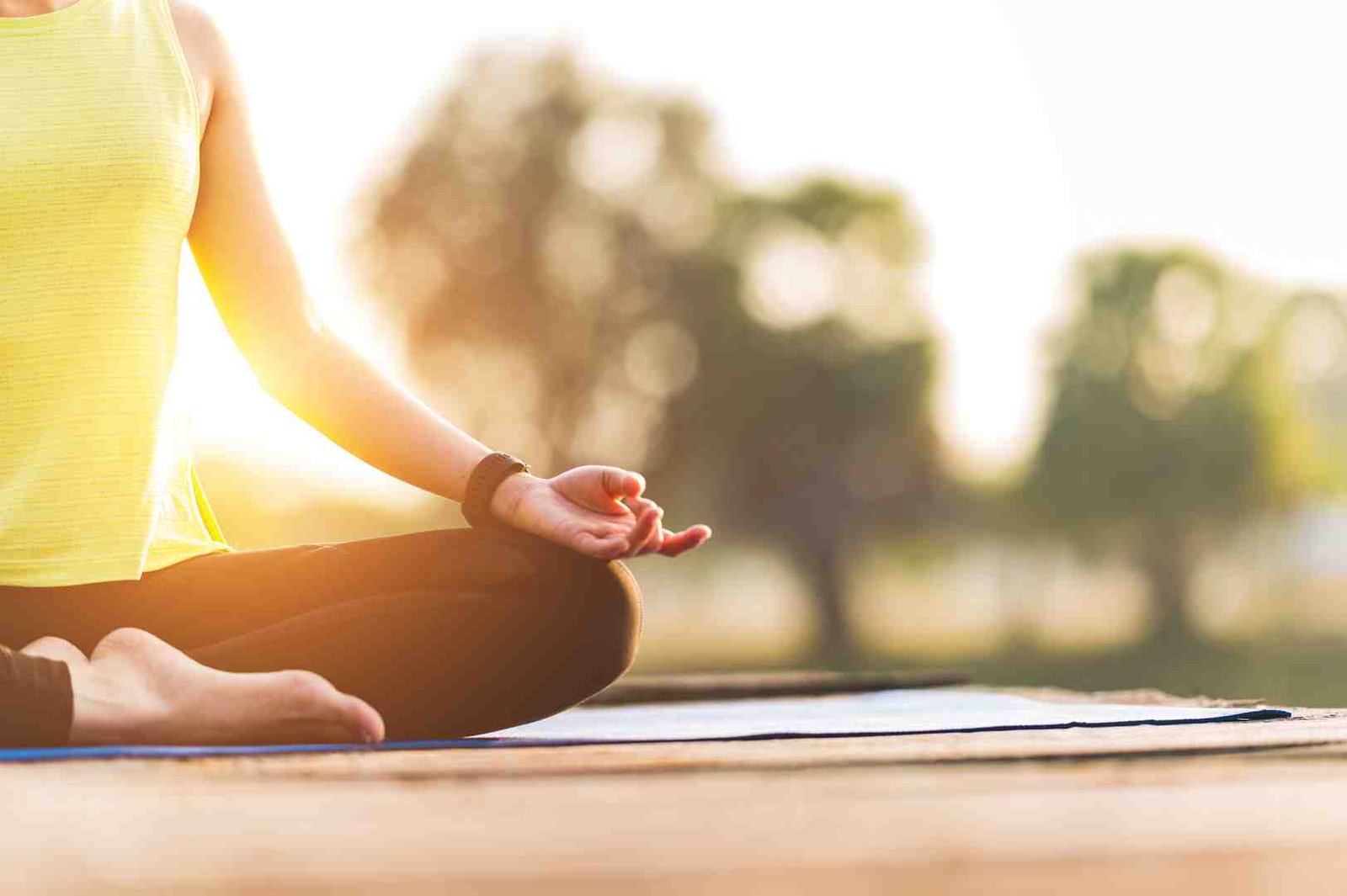 Woman practicing mindful breathing in a serene outdoor setting